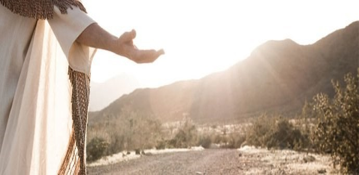 Jesus extending a welcoming hand in sunlight