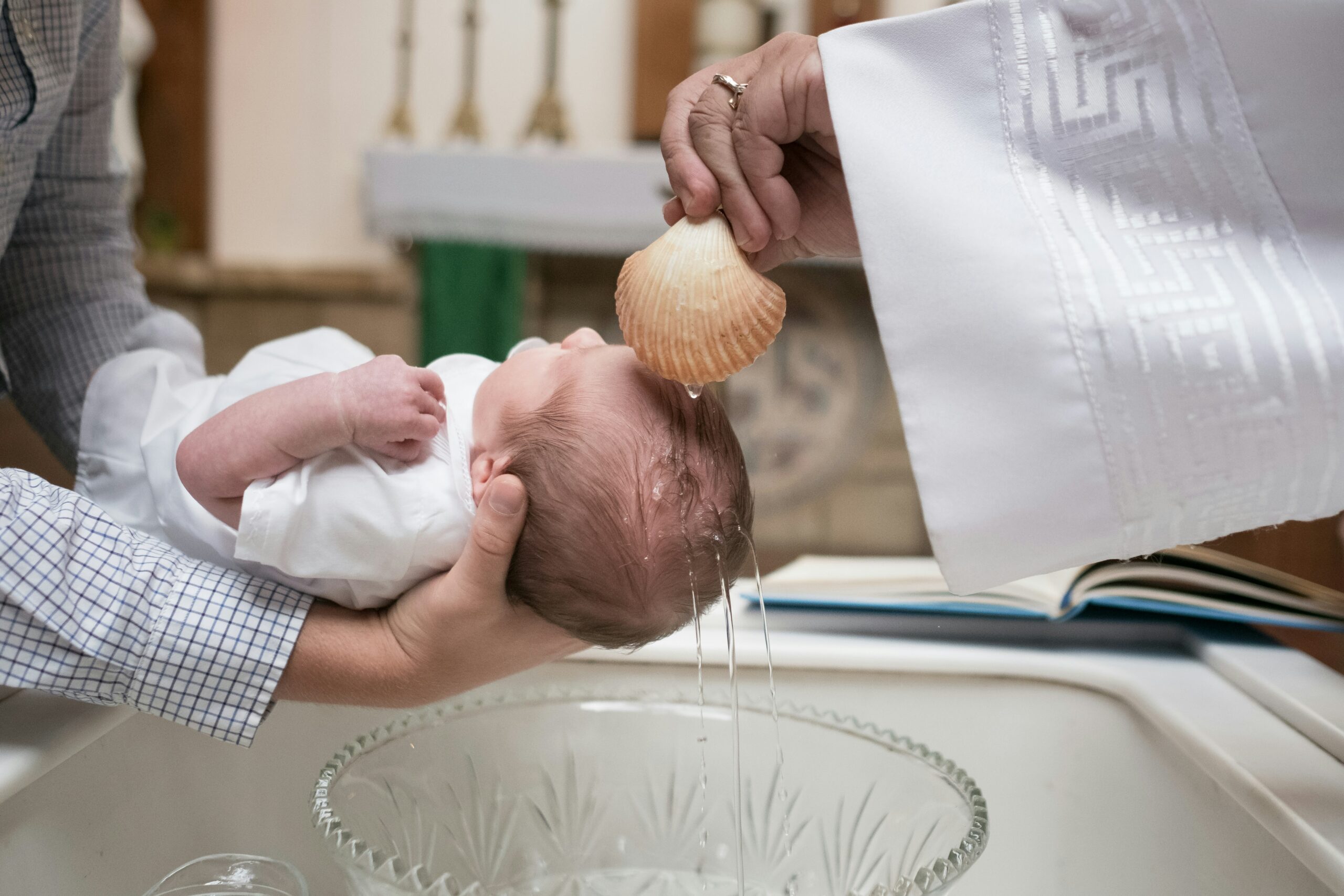 A child being baptized at St. Augustine Catholic Church